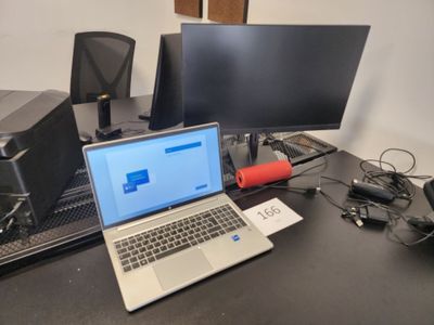 a laptop computer sitting on top of a desk next to a monitor
