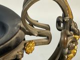 a black and gold vase with a handle on it