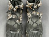 pair of women ' s black shoes with gold accents on them