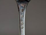 a close up of a fork with a piece of food on it