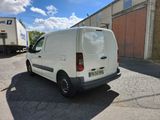 a white van that is parked in a parking lot