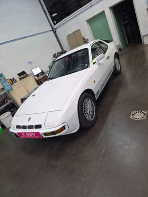 a white car parked inside of a building in a garage