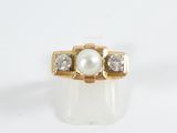 an image of a pearl and diamond ring on a white surface
