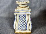 a small blue and white vase sitting on top of a table