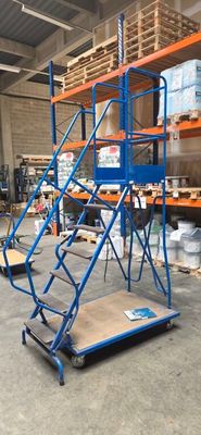 a blue platform with a ladder on it in a warehouse