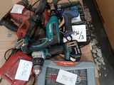 a pile of power tools on a pallet in a box