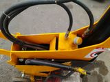 a small yellow machine with a hose attached to it