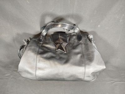 silver leather handbag with a star on the handle