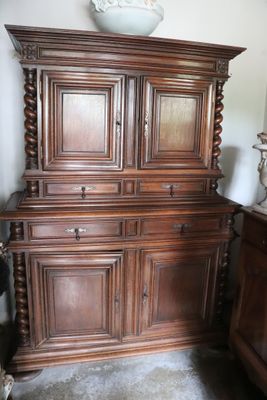 a large wooden cabinet with a bowl on top of it