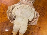 a doll that is laying down on a table