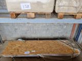 two mattresses sitting on pallets in a warehouse