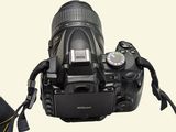 a black camera with a yellow strap on it