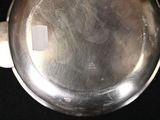 a close up of a silver pot on a black surface