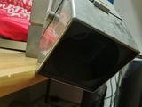 a microwave sitting on top of a wooden desk