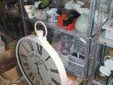 a clock that is sitting on a shelf in a room