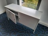 a white desk with a door open in a room