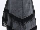 grey and black shawl with fringes on a mannequin dummy