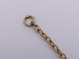 a close up of a gold chain with a clasp on a white surface