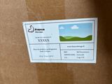 a cardboard box with a picture of a green field on it
