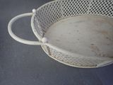 a white basket that has a handle on it