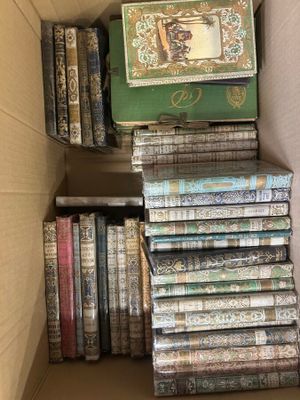 a box full of books that are stacked on top of each other