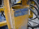 a close up of a yellow machine with wires attached to it