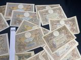 a pile of old currency sitting on top of a table