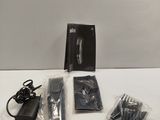 a box with a knife, scissors and other items on a table