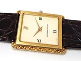 a watch that is sitting on a brown strap