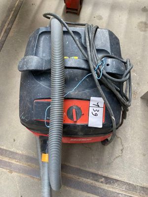 a vacuum that is sitting on the floor next to a bag