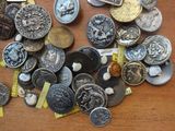 a pile of coins on a table with tags on it