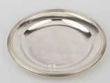 a silver plate on a white surface with a silver rim