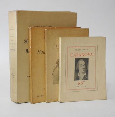 three books sitting on top of each other on a white surface