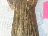 a statue of a man holding a glass in his hand