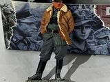 a small toy figure of a man standing on a snowboard