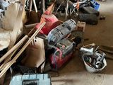 many tools that are sitting on the floor in the garage