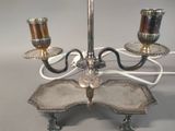 a silver candle holder with three candles on it