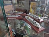 many model ships on display in a glass case