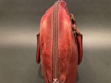a close up of a red purse on a table