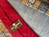 a red and blue tie with a brown label on it