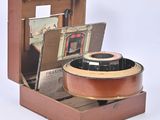 a small wooden box with a guitar inside of it