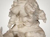 a statue of a woman holding a bird in her hands