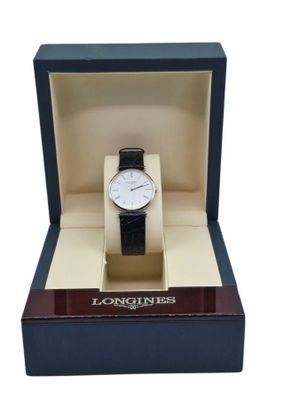 the watch is in a box with a black strap