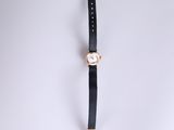 a close up of a watch on a white surface with a white background