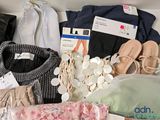 a lot of clothes and shoes in a box