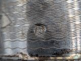 a close up of a metal object with a wave pattern on it