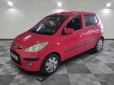 a picture of a red car parked in a garage