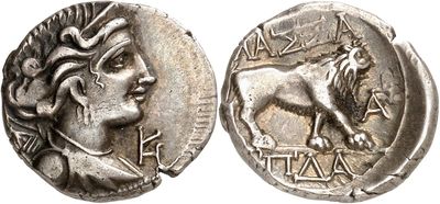 a silver coin with a woman and a lion on it