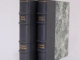 two books sitting on top of each other on a white surface