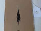 a notepad with a drawing of a bird on it